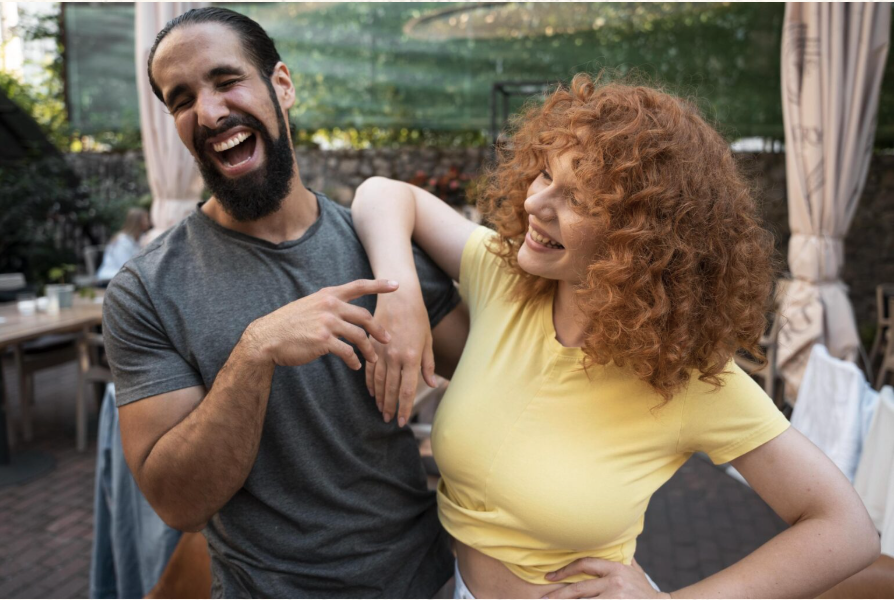 Couple laughing together outdoors