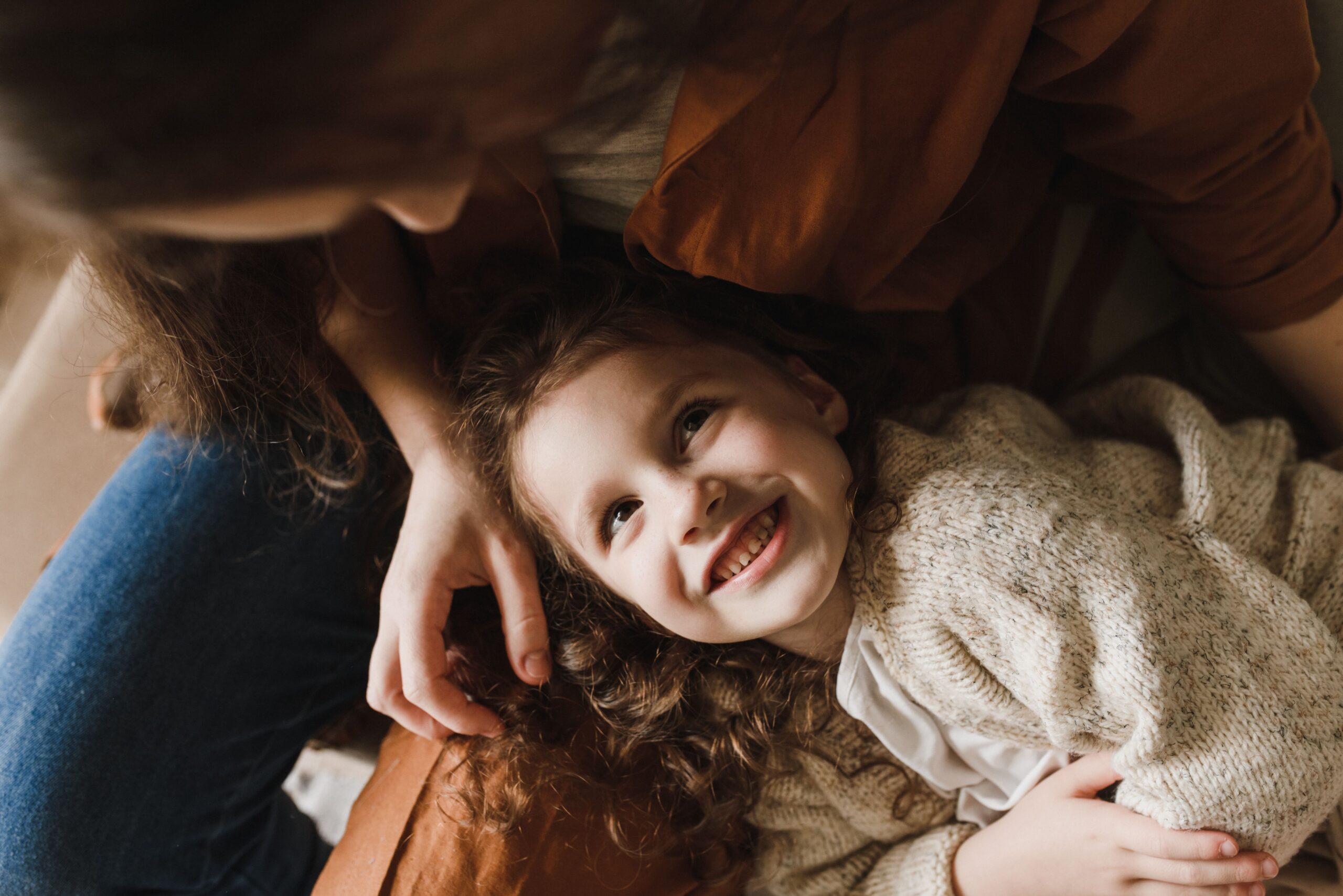 Parent and young child smiling together, child custody evaluations